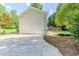 Exterior of home with two-car garage and a deck accessible by stairs at 125 Ashbury Ct, Dallas, GA 30157