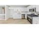 Open kitchen boasts stainless steel appliances, and bright lighting at 125 Ashbury Ct, Dallas, GA 30157