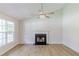 Bright living room features beautiful floors, fireplace and a modern ceiling fan at 125 Ashbury Ct, Dallas, GA 30157