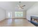 Light-filled living room features high ceilings, fireplace, luxury vinyl flooring and a front door at 125 Ashbury Ct, Dallas, GA 30157