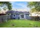 Fenced backyard boasts a well-maintained lawn, perfect for outdoor activities at 1919 Cheatham Woods Sw Dr, Marietta, GA 30008