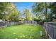 A fenced in backyard with lush green lawn at 1919 Cheatham Woods Sw Dr, Marietta, GA 30008