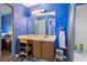 Blue bathroom with a shower and tub combo and a spacious vanity and sink at 1919 Cheatham Woods Sw Dr, Marietta, GA 30008