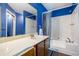 This bathroom features a tub with shower and a large vanity sink at 1919 Cheatham Woods Sw Dr, Marietta, GA 30008