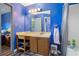 Blue bathroom with vanity, tub-shower combo and matching blue walls at 1919 Cheatham Woods Sw Dr, Marietta, GA 30008