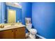 Powder room with blue walls, single sink vanity, and commode at 1919 Cheatham Woods Sw Dr, Marietta, GA 30008