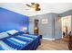 Spacious bedroom with laminate flooring, en-suite access, and two-tone gray and blue paint at 1919 Cheatham Woods Sw Dr, Marietta, GA 30008