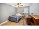 Neutral bedroom with laminate floors, window and ceiling fan at 1919 Cheatham Woods Sw Dr, Marietta, GA 30008