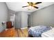 Bedroom with laminate floors, ceiling fan and three entryways at 1919 Cheatham Woods Sw Dr, Marietta, GA 30008