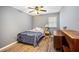 Bedroom featuring ceiling fan, laminate flooring, and neutral grey walls at 1919 Cheatham Woods Sw Dr, Marietta, GA 30008