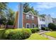 Inviting two-story townhome showcasing a brick facade and a professionally landscaped yard at 1919 Cheatham Woods Sw Dr, Marietta, GA 30008