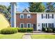 Charming two-story townhome featuring a well-maintained front lawn and colorful landscaping at 1919 Cheatham Woods Sw Dr, Marietta, GA 30008