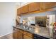 Kitchen features granite countertops, stainless sink, wood cabinets, and an open view to the living area at 1919 Cheatham Woods Sw Dr, Marietta, GA 30008