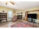 Cozy living room with a brick fireplace, hardwood floors, and comfortable furnishings at 1919 Cheatham Woods Sw Dr, Marietta, GA 30008