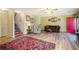 Inviting living room with hardwood floors, a cozy couch, and stairs leading to the second level at 1919 Cheatham Woods Sw Dr, Marietta, GA 30008