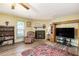 Bright living room with wood floors, a fireplace, and a ceiling fan at 1919 Cheatham Woods Sw Dr, Marietta, GA 30008