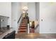 View of open staircase with wooden steps, red carpet runners, and decorative wooden floors at 1919 Cheatham Woods Sw Dr, Marietta, GA 30008
