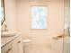 Bright bathroom features a modern tub next to a window at 3050 Baymount Dr, Lawrenceville, GA 30043