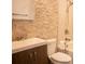 Bright bathroom with toilet, vanity, shower and decorative stone accent wall at 3050 Baymount Dr, Lawrenceville, GA 30043