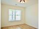Bright bedroom with hardwood floors and a large window at 3050 Baymount Dr, Lawrenceville, GA 30043