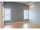 Sunlit bedroom with neutral walls, hardwood floors, and modern windows at 3050 Baymount Dr, Lawrenceville, GA 30043