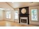 Living room highlighting a fireplace with marble accents, surrounded by two windows for abundant natural light at 3050 Baymount Dr, Lawrenceville, GA 30043