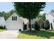 Charming home with manicured lawn, mature tree, and a well-maintained flower bed in the front yard at 3050 Baymount Dr, Lawrenceville, GA 30043