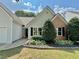 Well-maintained home with beautiful landscaping, fresh green lawn, and a welcoming entrance at 3050 Baymount Dr, Lawrenceville, GA 30043