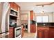 Well-lit kitchen with stainless steel appliances and dark countertops and backsplash at 3050 Baymount Dr, Lawrenceville, GA 30043
