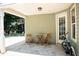 Covered patio featuring outdoor table, chairs, lighting, and backyard access at 3050 Baymount Dr, Lawrenceville, GA 30043