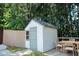 Backyard shed and dining set sitting on a raised patio with stairs at 3050 Baymount Dr, Lawrenceville, GA 30043