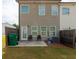 Backyard with a small patio, furniture, fence and green space at 3375 Highbury Way, Lithonia, GA 30038