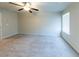 Spacious carpeted bedroom featuring ceiling fan and window with blinds at 3375 Highbury Way, Lithonia, GA 30038