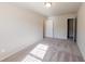 Neutral bedroom with plush carpet, large window, and doors that lead to the closet and rest of the home at 3375 Highbury Way, Lithonia, GA 30038
