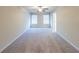 Bright and airy bedroom with neutral walls, two windows, and carpeted floors at 3375 Highbury Way, Lithonia, GA 30038