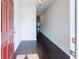 Inviting entryway with dark wood floors, neutral walls, and a bright red front door at 3375 Highbury Way, Lithonia, GA 30038