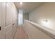Carpeted upstairs hallway featuring railing and closet at 3375 Highbury Way, Lithonia, GA 30038
