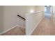 Upstairs hallway with carpeted floors and wooden handrail at 3375 Highbury Way, Lithonia, GA 30038