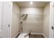 Dedicated laundry room with washer hookups and upper rack for extra storage at 3375 Highbury Way, Lithonia, GA 30038