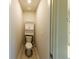 Tight powder room featuring a toilet and storage shelves at 3375 Highbury Way, Lithonia, GA 30038