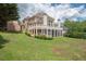 Sprawling backyard with a lush lawn and a large, covered patio, perfect for outdoor living at 4054 Lyon Blvd, Atlanta, GA 30331
