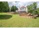 A large backyard is complete with multiple retaining walls and gorgeous green grass at 4054 Lyon Blvd, Atlanta, GA 30331