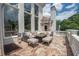 This grand home has a beautiful terrace with stone floors and comfortable outdoor furniture at 4054 Lyon Blvd, Atlanta, GA 30331