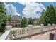 Stone balcony with white balusters offers a beautiful view of the back yard and nearby properties at 4054 Lyon Blvd, Atlanta, GA 30331