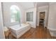 Luxurious bathroom features a standalone tub, shiplap walls, and a unique glass block window at 4054 Lyon Blvd, Atlanta, GA 30331