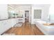 Luxurious bathroom featuring a soaking tub, white cabinetry, and a glass block window at 4054 Lyon Blvd, Atlanta, GA 30331