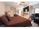 Bedroom with a large TV, a ceiling fan, and dark wooden furniture at 4054 Lyon Blvd, Atlanta, GA 30331