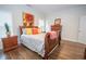 Comfortable bedroom features hardwood floors, bright accents and a colorful sunflower painting at 4054 Lyon Blvd, Atlanta, GA 30331