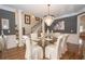 Dining room features elegant chandelier, glass table, seating for six, and staircase to the second floor at 4054 Lyon Blvd, Atlanta, GA 30331
