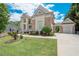 Stunning home with brick and stucco, showcasing a well-manicured lawn and a two-car garage at 4054 Lyon Blvd, Atlanta, GA 30331